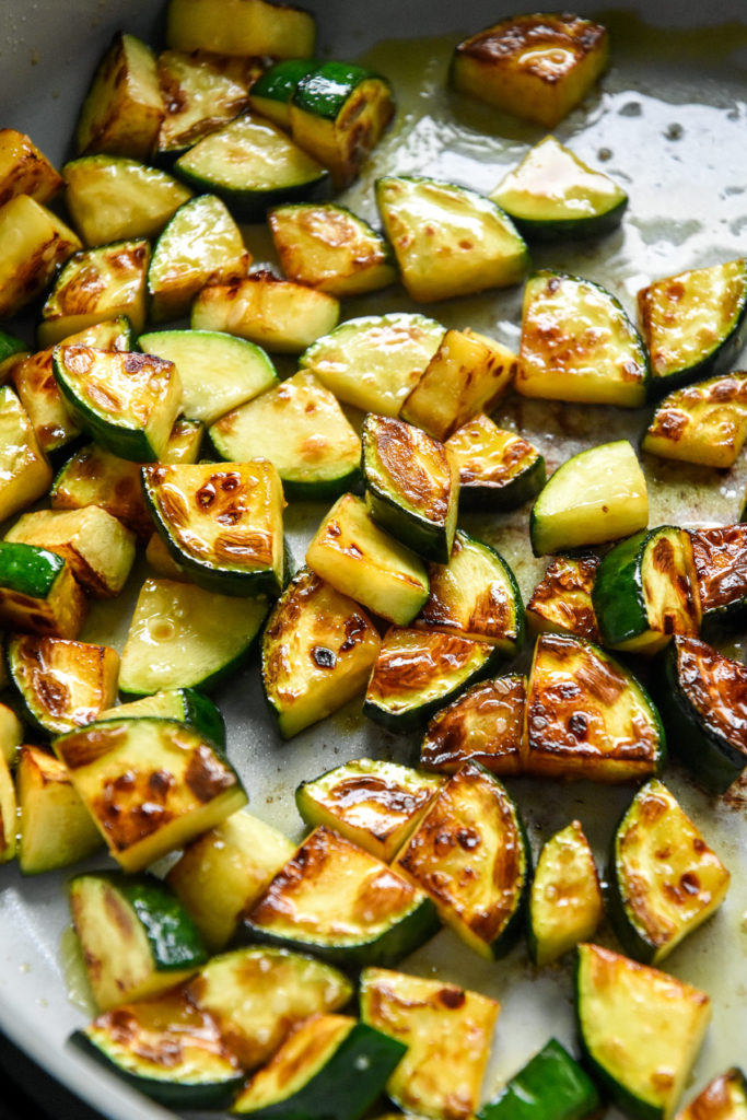 browning zucchini in a nonstick pan.