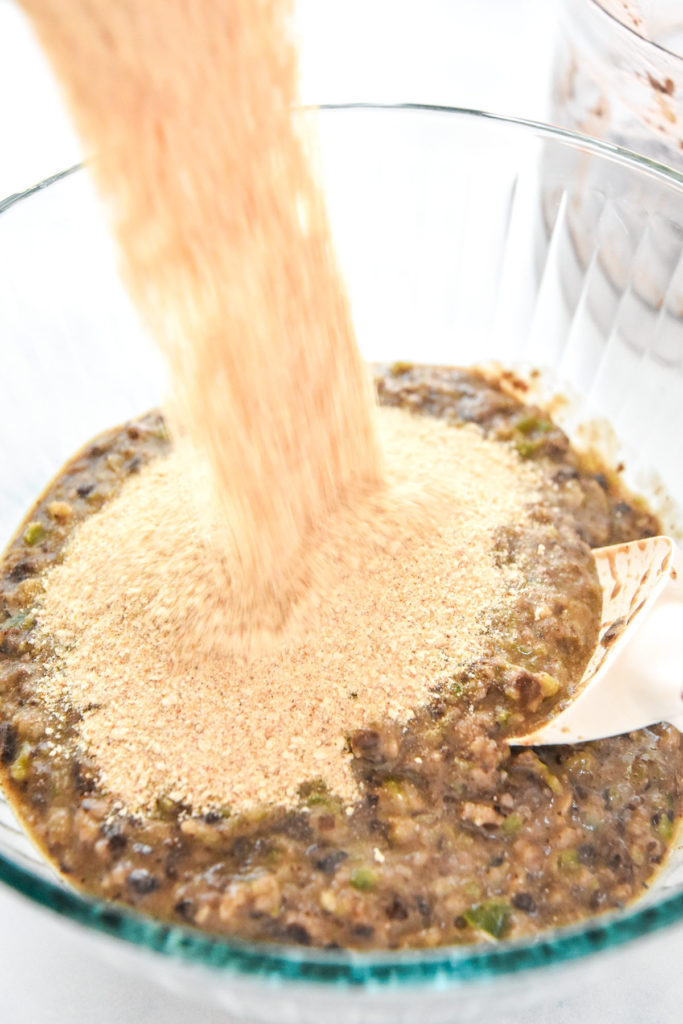 pouring breadcrumbs into a bowl.