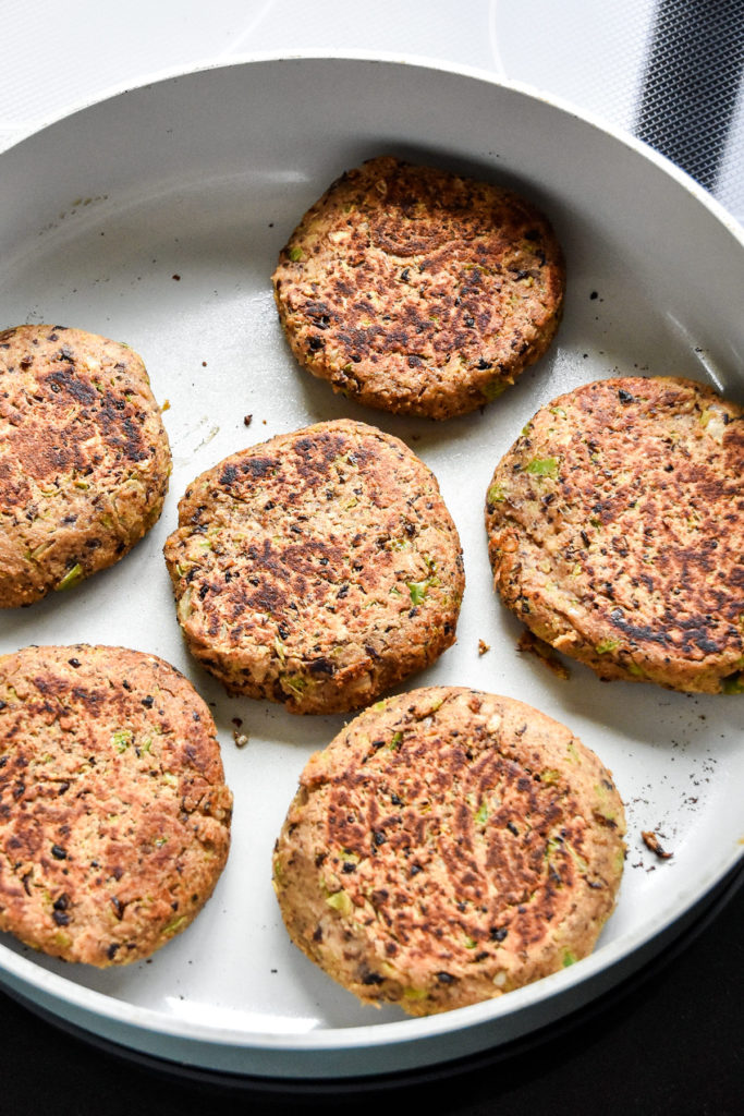 cooked black bean burger patties in a pan.