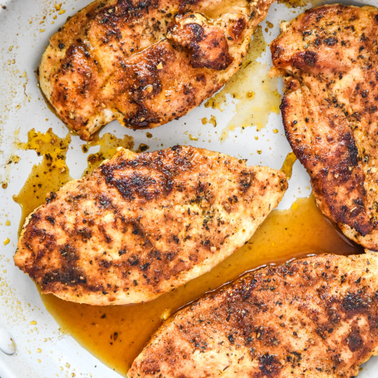 thin sliced stovetop chicken breasts just cooked in a pan.