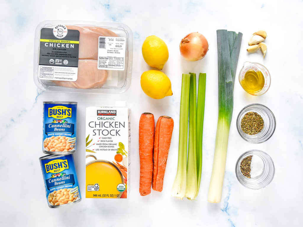 ingredients and vegetables required to make soup sitting on a counter.