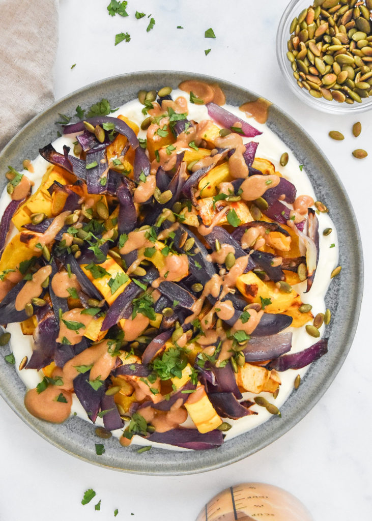 roasted squash salad with whipped feta on a serving plate.