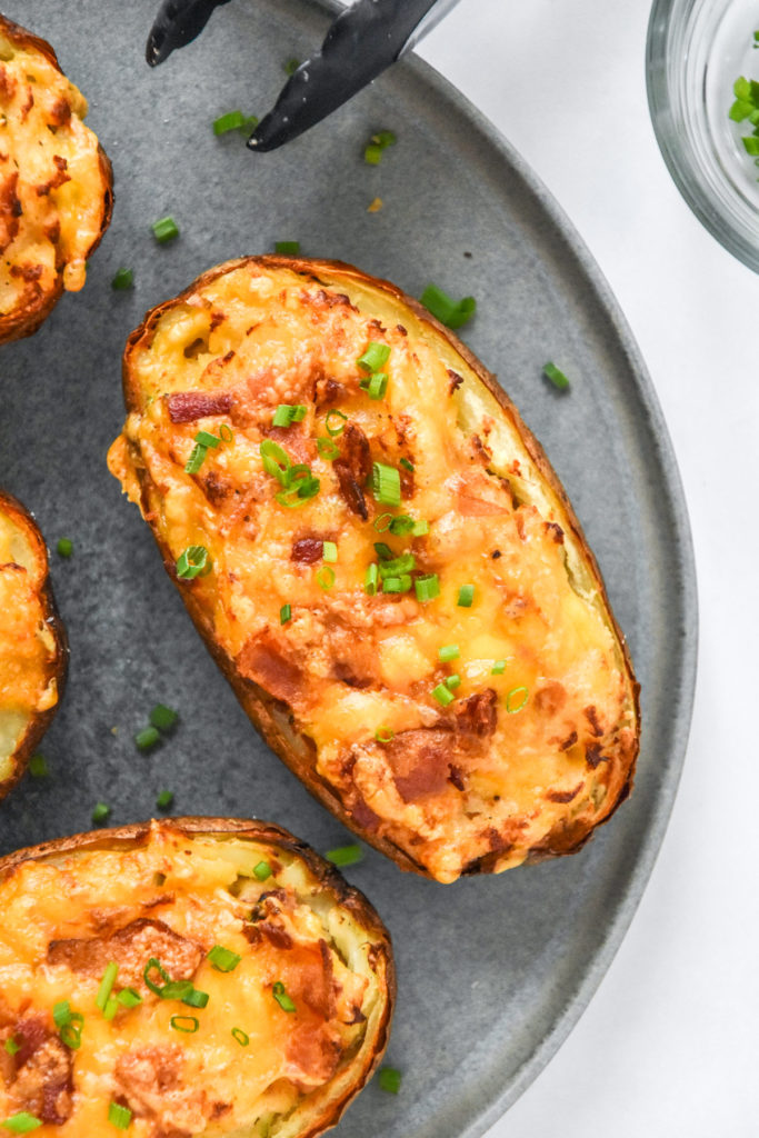 air fryer twice baked potatoes golden brown with chives on top.