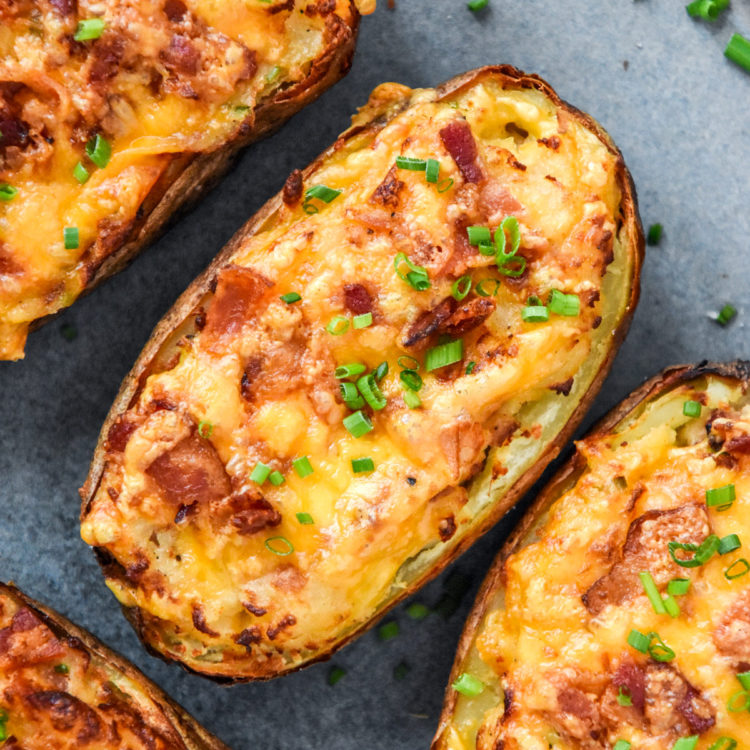 Air Fryer Twice Baked Potatoes with cheese, bacon bits and chives on top.