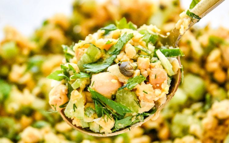 herby lemon mashed chickpea salad on a spoon.
