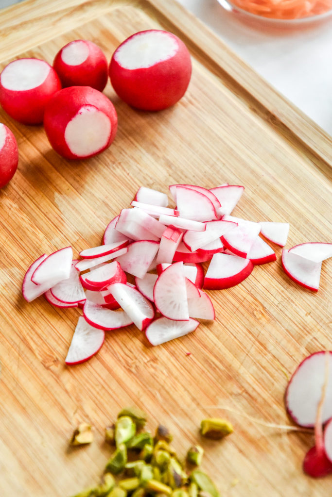 thinly sliced radish on a cutting board.