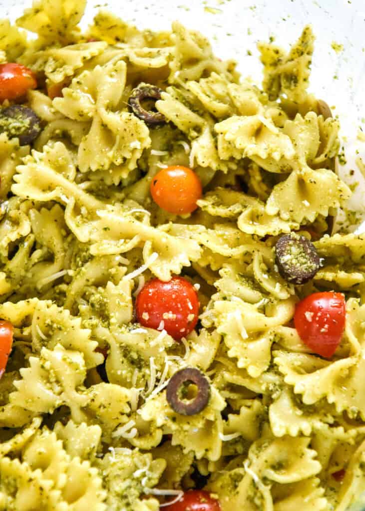 easy pesto pasta salad mixed up in a large bowl.