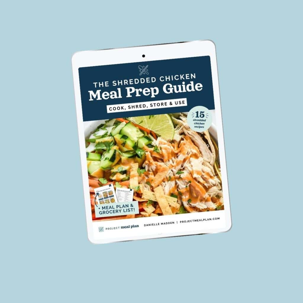 the shredded chicken meal prep guide on ipad with blue background.