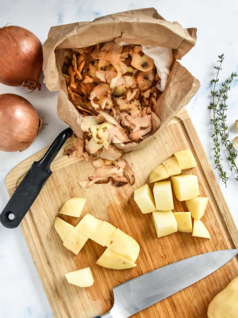 cutting and preparing potatoes on a wooden cutting board.