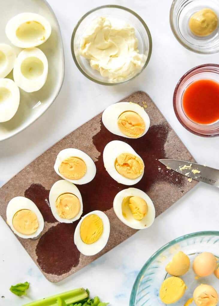 hard boiled eggs cut in half removing the yolks.