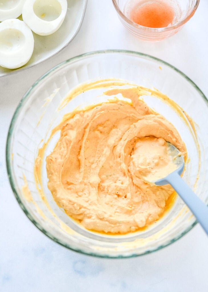 mixed up egg yolk mixture in a glass bowl.