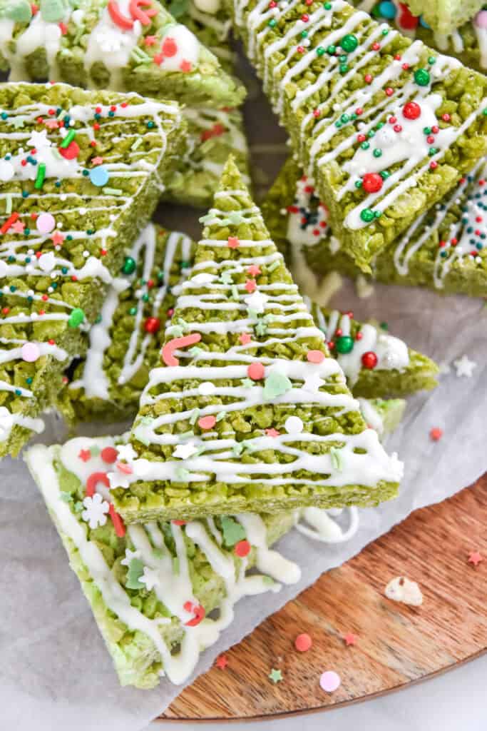 christmas tree rice krispies treats decorated with white chocolate and sprinkles.