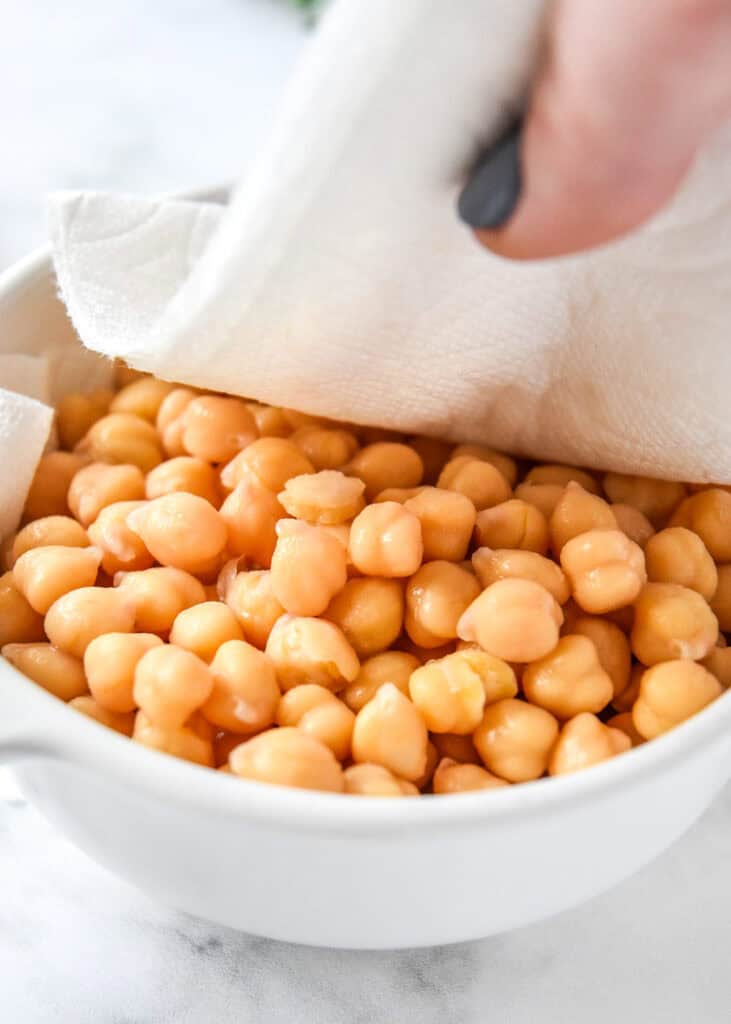 patting chickpeas dry with a paper towel.