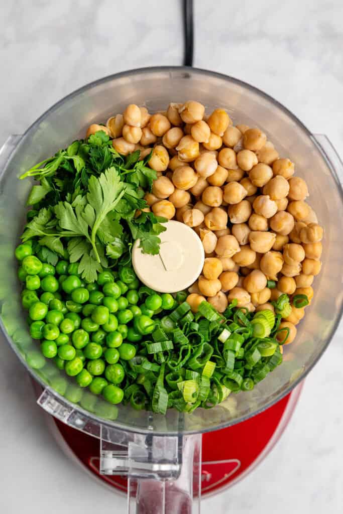 chickpeas, peas and herbs in a food processor before blending.