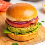 herby chickpea veggie burgers with a brioche bun and toppings.