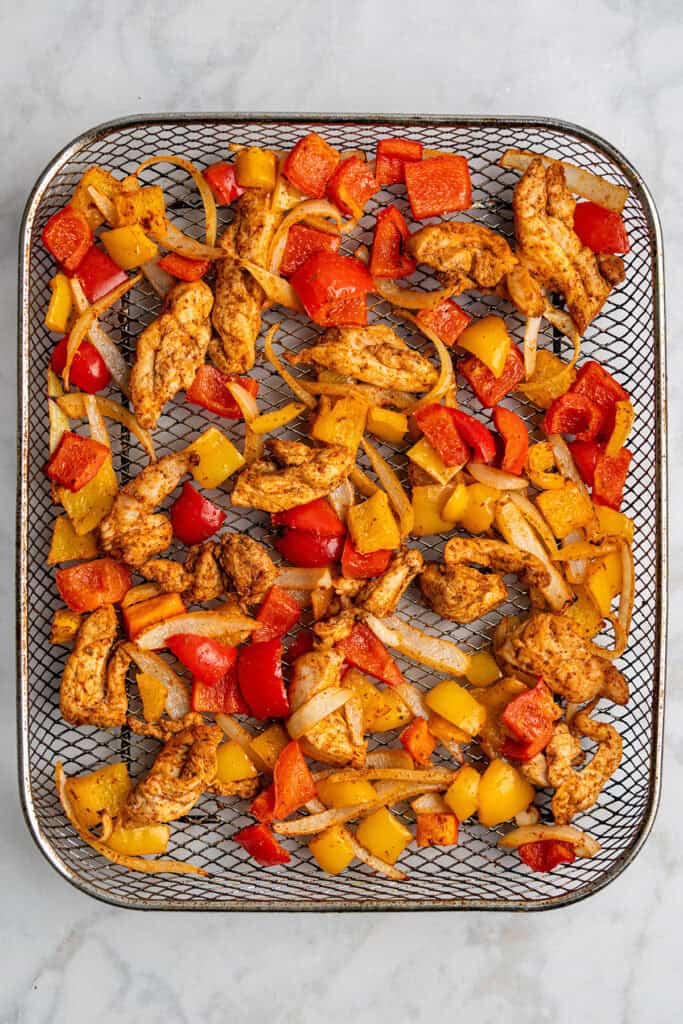 cooked air fryer chicken fajitas on the air fryer rack.