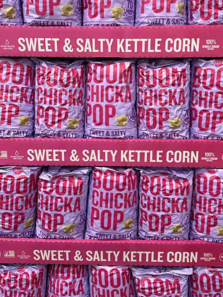bags of popcorn on a pink shelf.