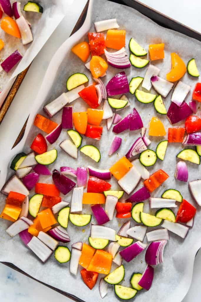 cut raw veggies on a sheet pan.