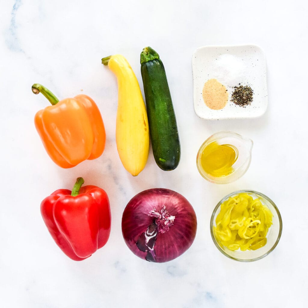 squash, peppers and a red onion before cutting for roasting.