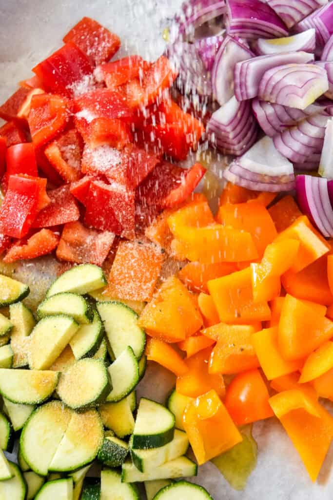 easy oven roasted summer vegetables on a sheet pan before roasting.