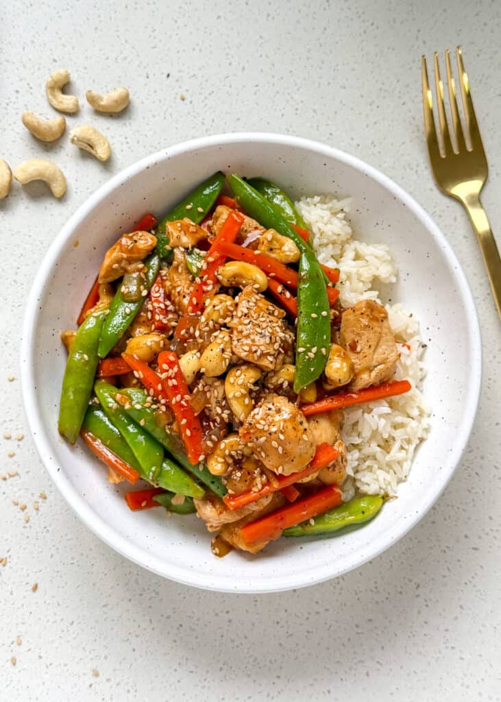 cashew chicken meal prep in a bowl with rice.