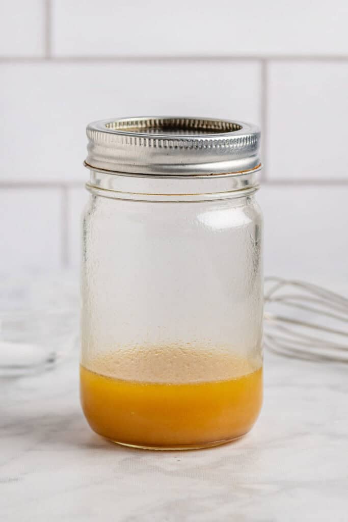 mason jar of maple vinaigrette dressing for the fall pasta salad.